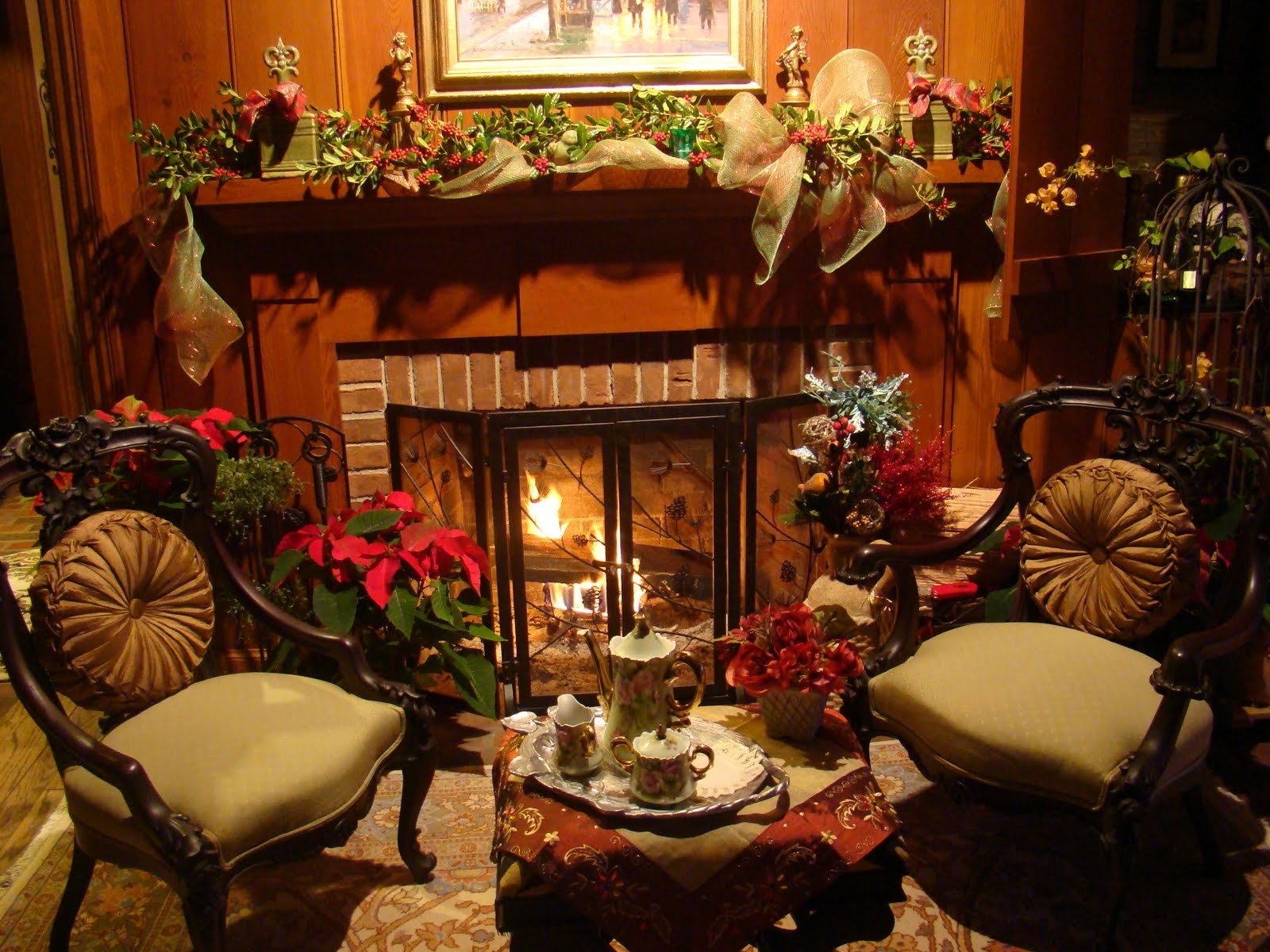 A cozy fireplace adorned with Christmas ornaments and holiday greenery, surrounded by elegant chairs and festive decorations, creating a warm and inviting holiday atmosphere.