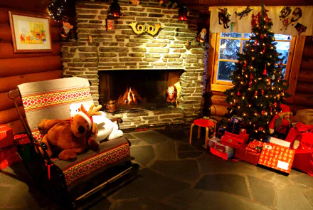 A cozy holiday scene featuring a stone fireplace, a stuffed animal, a beautifully decorated Christmas tree, and wrapped gifts, creating a warm atmosphere for Christmas celebrations.