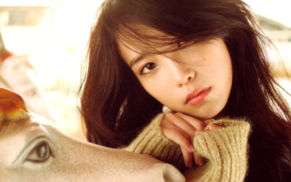 HD PC desktop wallpaper featuring Korean music artist IU with a soft, warm-toned portrait highlighting her natural beauty and thoughtful expression.