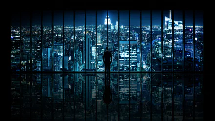 A person stands overlooking a panoramic nighttime view of Manhattan's illuminated skyline, captured in a high-definition desktop wallpaper.