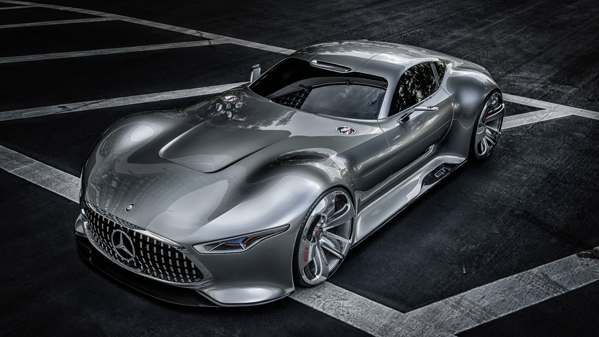 Sleek silver Mercedes-Benz AMG Vision Gran Turismo sports car showcased in an urban setting, captured as a high-definition PC desktop wallpaper and background.