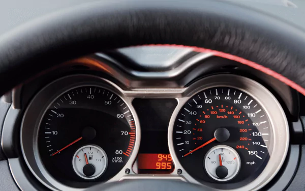 Close-up view of a Proton vehicle's dashboard displaying speedometer, tachometer, and fuel gauges in a high-definition PC desktop wallpaper background.