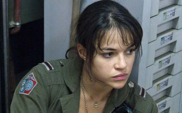 HD desktop wallpaper featuring Michelle Rodriguez in a scene from the movie Avatar, showing her in military attire with a pensive expression.