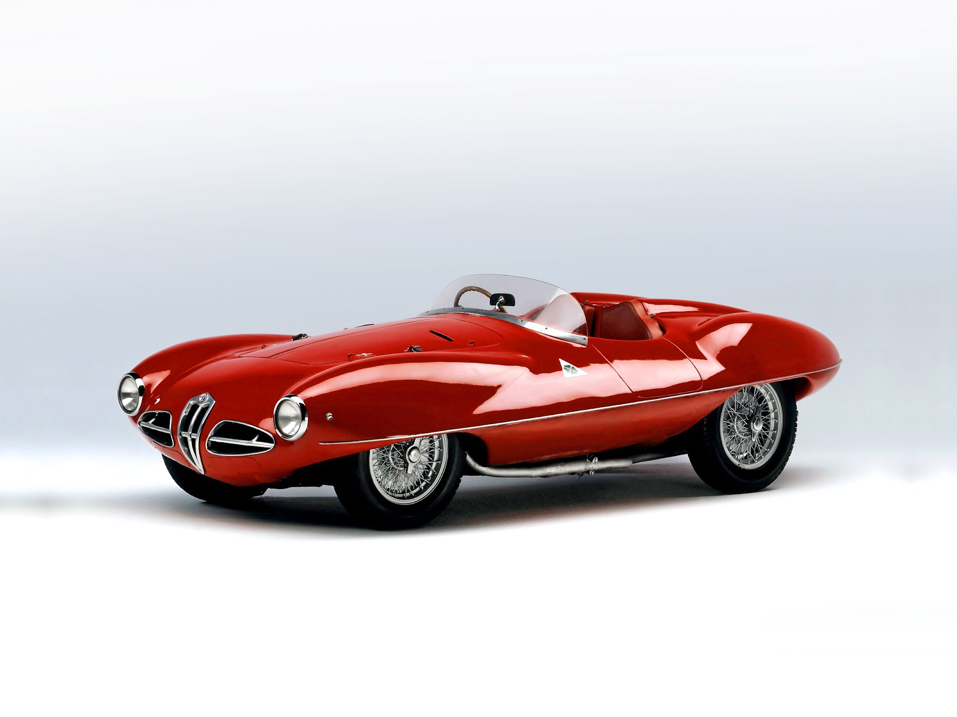 HD desktop wallpaper featuring a red Alfa Romeo Disco Volante, showcasing the classic vehicle's sleek and aerodynamic design.