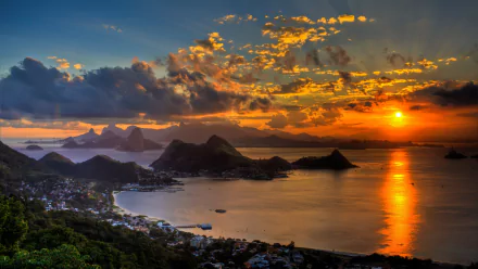 Stunning sunset over Rio de Janeiro with dramatic clouds reflecting in the ocean, creating a serene and vibrant HD desktop wallpaper and background.