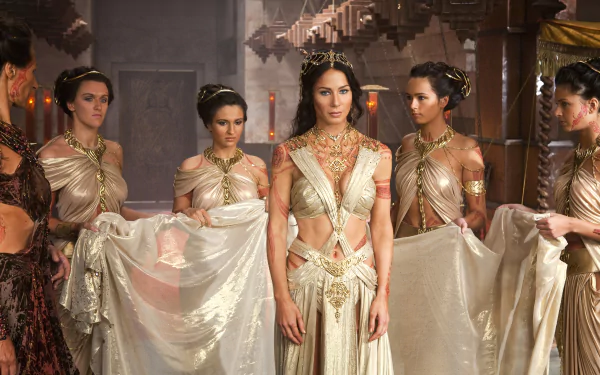 A 4K Ultra HD desktop wallpaper featuring Lynn Collins as Dejah Thoris from the movie John Carter, dressed in an elegant, ornate gown surrounded by attendants.