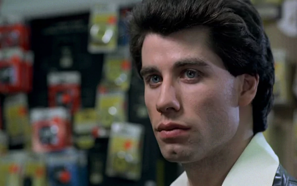 HD PC desktop wallpaper featuring Tony Manero from the movie Saturday Night Fever with a focused expression and iconic 1970s style.