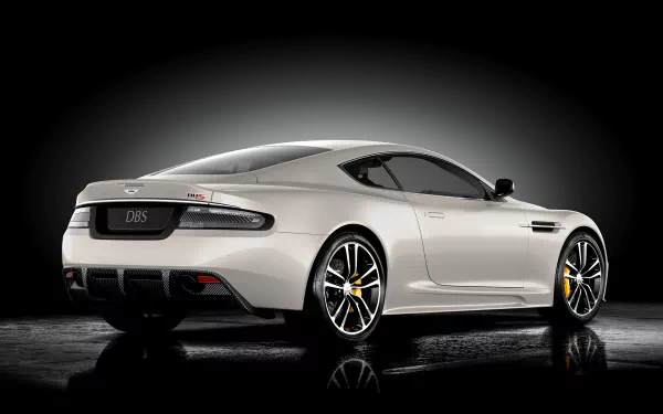 Aston Martin DBS showcased in a sleek silver finish, captured in a high-definition PC desktop wallpaper with a dark gradient background highlighting the vehicle's design.