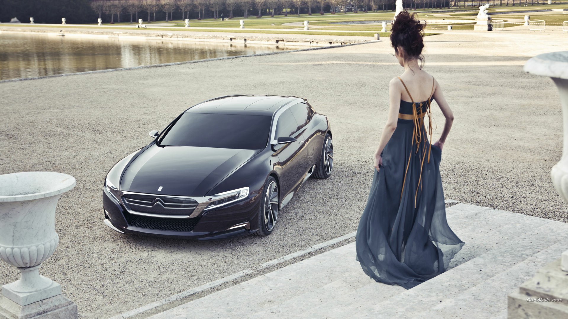 HD PC desktop wallpaper of the Citroën Numero 9 Concept vehicle parked on grand estate steps as a woman in an evening gown looks on.