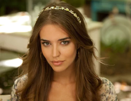 A high-definition desktop wallpaper featuring Clara Alonso, showcasing her with flowing hair and a delicate headband, set against a softly blurred natural background.