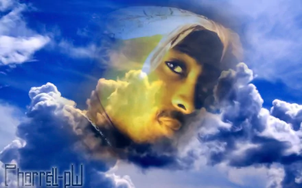 A vibrant HD desktop wallpaper featuring 2Pac’s face emerging from ethereal clouds against a blue sky, blending music and artistry in a captivating visual.