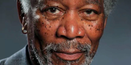High-definition desktop wallpaper featuring a close-up portrait of a distinguished man with a grey beard and a warm gaze.