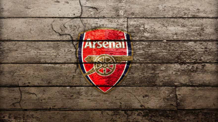 HD wallpaper featuring the Arsenal F.C. logo against a textured wooden background, capturing the essence of sports and team spirit.