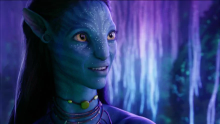 HD PC desktop wallpaper featuring a close-up of a character from the movie Avatar, set against a glowing, bioluminescent forest background.
