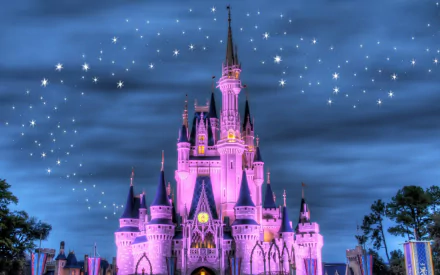HD desktop wallpaper featuring the iconic man-made Disneyland castle illuminated in pink against a twilight sky with sparkling stars.