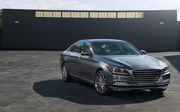 HD PC desktop wallpaper featuring a sleek Hyundai Genesis sedan parked on a paved surface in front of a modern dark building.