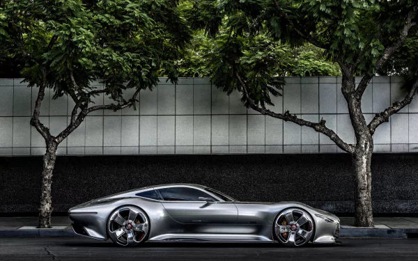 Silver Mercedes-Benz AMG Vision Gran Turismo parked on a street under green trees, captured in a high-definition PC desktop wallpaper.