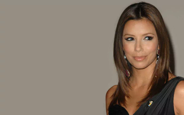 HD desktop wallpaper showing a smiling brunette woman in a black dress with dangling earrings, posed against a neutral beige background.