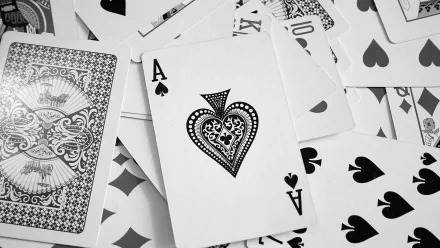 A high-definition PC desktop wallpaper featuring a close-up of playing cards, prominently displaying an intricately designed Ace of Spades surrounded by other cards.