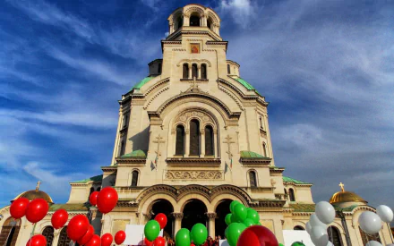 HD PC desktop wallpaper: Alexander Nevsky Cathedral's ornate facade beneath a vivid blue sky, framed by red, green and white balloons — religious landmark.