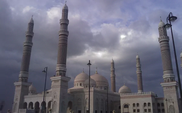 Religious HD PC desktop wallpaper background showing Al Saleh Mosque with domes and towering minarets beneath a dramatic cloudy sky.