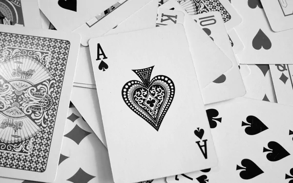 A high-definition PC desktop wallpaper featuring a close-up of playing cards, prominently displaying an intricately designed Ace of Spades surrounded by other cards.