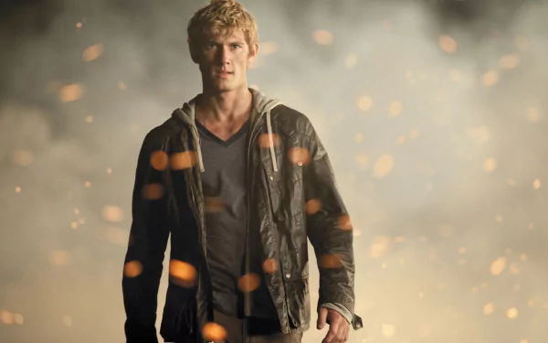 A striking HD wallpaper from the movie I Am Number Four, featuring a blonde character in a jacket standing amidst glowing sparks and dramatic smoky background.