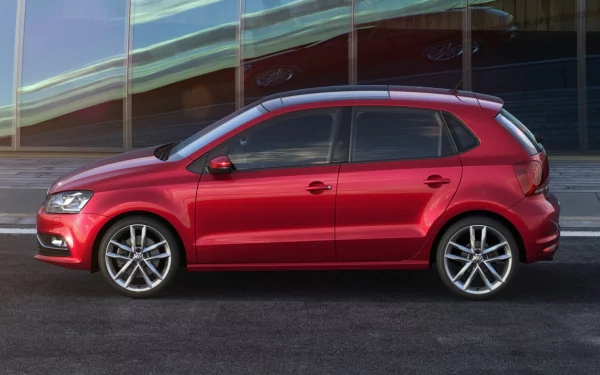 HD PC desktop wallpaper featuring a sleek red Volkswagen Polo parked in front of a modern glass building.