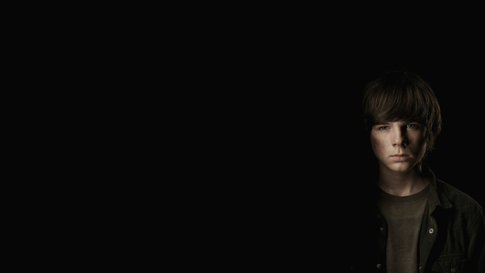 A dark, moody 4K Ultra HD desktop wallpaper featuring a character from The Walking Dead TV show partially illuminated against a black background.