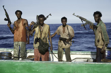 HD wallpaper from Captain Phillips featuring four individuals on a boat with the ocean in the background.