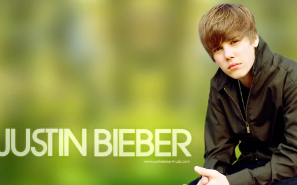 HD desktop wallpaper featuring a person with the text JUSTIN BIEBER on a blurred green background.