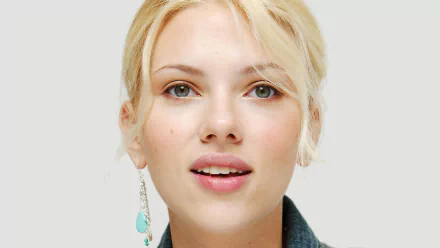 A close-up portrait of Scarlett Johansson, showcasing her natural beauty and expressive features, designed as an HD desktop wallpaper and background.