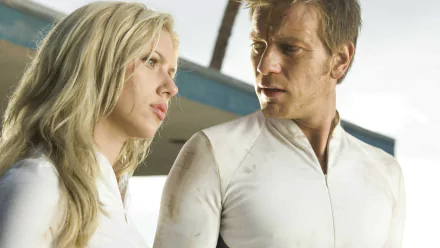 HD PC desktop wallpaper featuring Ewan McGregor and Scarlett Johansson in a scene from the movie The Island, both dressed in white futuristic attire.