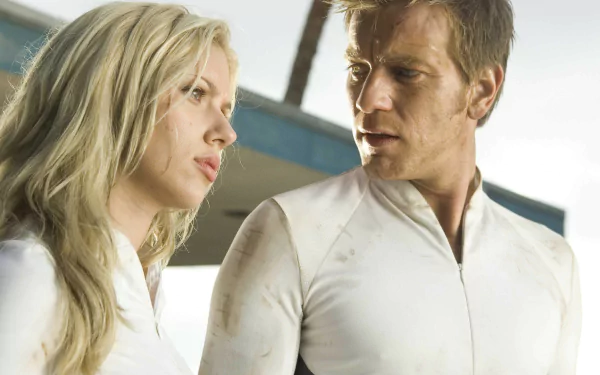 HD PC desktop wallpaper featuring Ewan McGregor and Scarlett Johansson in a scene from the movie The Island, both dressed in white futuristic attire.