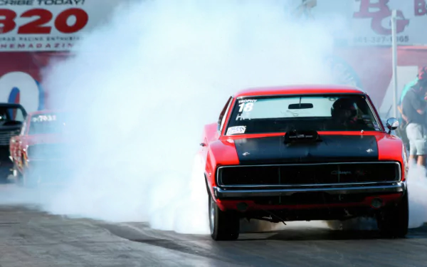 A striking Dodge Charger races down the track, surrounded by a cloud of smoke, showcasing its powerful presence in this vibrant 8K Ultra HD PC desktop wallpaper.