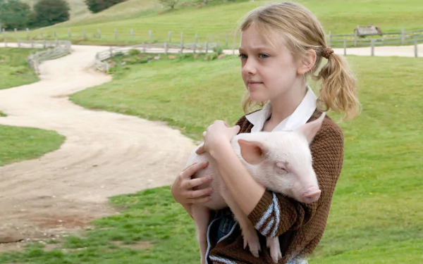 Dakota Fanning as Fern in Charlotte's Web (2006), cradling a piglet in a serene farm setting, capturing the essence of friendship and childhood in this heartwarming tale.