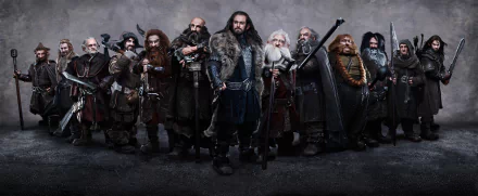 A group of dwarves from *The Hobbit: An Unexpected Journey* stands together in an HD wallpaper, showcasing their distinct personalities and attire from *The Lord of the Rings* universe.