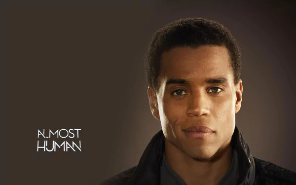 HD wallpaper featuring a man from Almost Human with text, designed for desktop backgrounds.