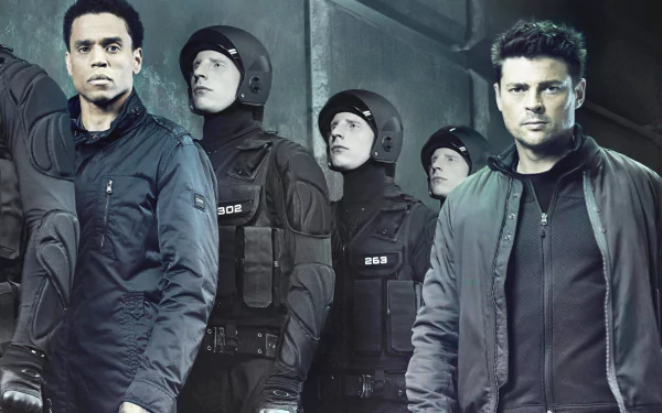 HD desktop wallpaper featuring Karl Urban from Almost Human, with characters in futuristic law enforcement gear.