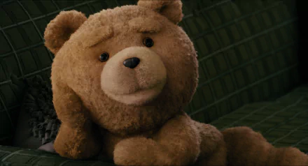 HD PC desktop wallpaper featuring Ted, the lovable teddy bear character from the movie Ted, with a soft, friendly expression on a dark background.
