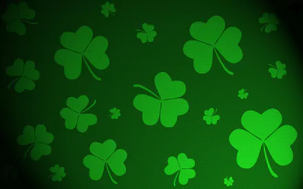 A vibrant green background featuring various shamrocks, celebrating St. Patrick's Day, designed as a high-definition wallpaper for PC desktops.
