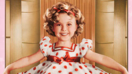 HD PC desktop wallpaper featuring a classic portrait of Shirley Temple in a polka-dot dress with a red bow, smiling against a vintage backdrop.