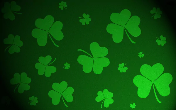 A vibrant green background featuring various shamrocks, celebrating St. Patrick's Day, designed as a high-definition wallpaper for PC desktops.