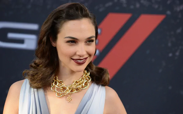 Gal Gadot, the Israeli actress and celebrity, poses stylishly with a statement necklace, set against a dramatic backdrop, creating an engaging HD desktop wallpaper.