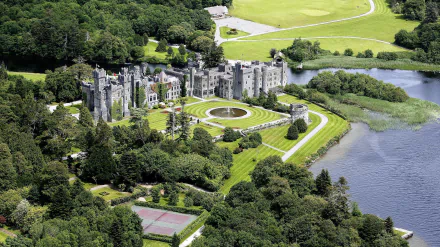 Aerial view of Ashford Castle surrounded by lush greenery and water, captured in high definition as a man-made HD PC desktop wallpaper and background.
