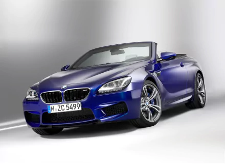 HD PC desktop wallpaper featuring a sleek blue BMW M6 Convertible vehicle against a clean, light gray background.