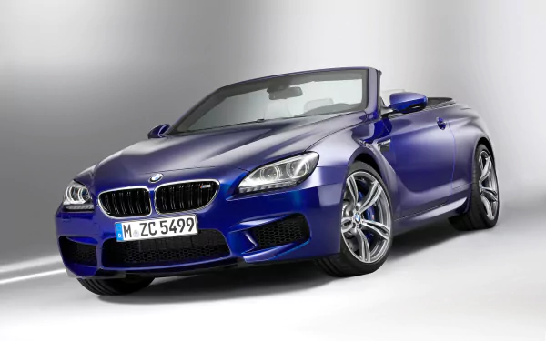 HD PC desktop wallpaper featuring a sleek blue BMW M6 Convertible vehicle against a clean, light gray background.