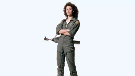 Sigourney Weaver stands confidently in a military jumpsuit, showcasing her iconic role in the film Alien. This HD desktop wallpaper captures her strength and determination.