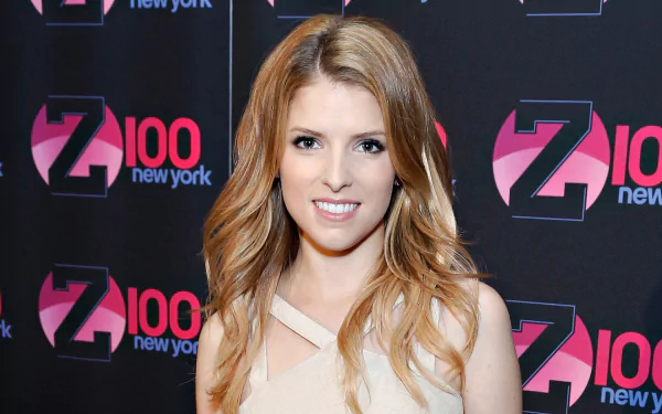 Anna Kendrick, an American actress and celebrity, smiles confidently in this HD desktop wallpaper, set against a backdrop featuring the Z100 New York logo.