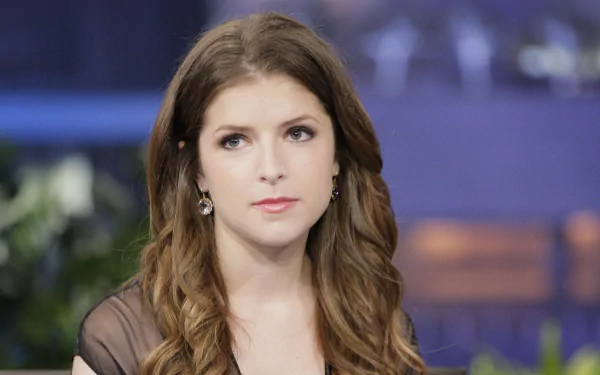 A close-up of actress Anna Kendrick, showcasing her wavy brown hair and thoughtful expression. This HD image serves as a stylish desktop wallpaper for fans of the American celebrity.